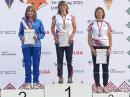 Nadia Scharlau, KO4ADV, on medal podium after receiving the silver medal for W55 80m Classic. From left to right: Nadia Scharlau, KO4ADV (USA), Jitka Šimáčková (Czech Republic), Renata Čadová (Czech Republic) [Photo courtesy of Charles Scharlau, NZØI]